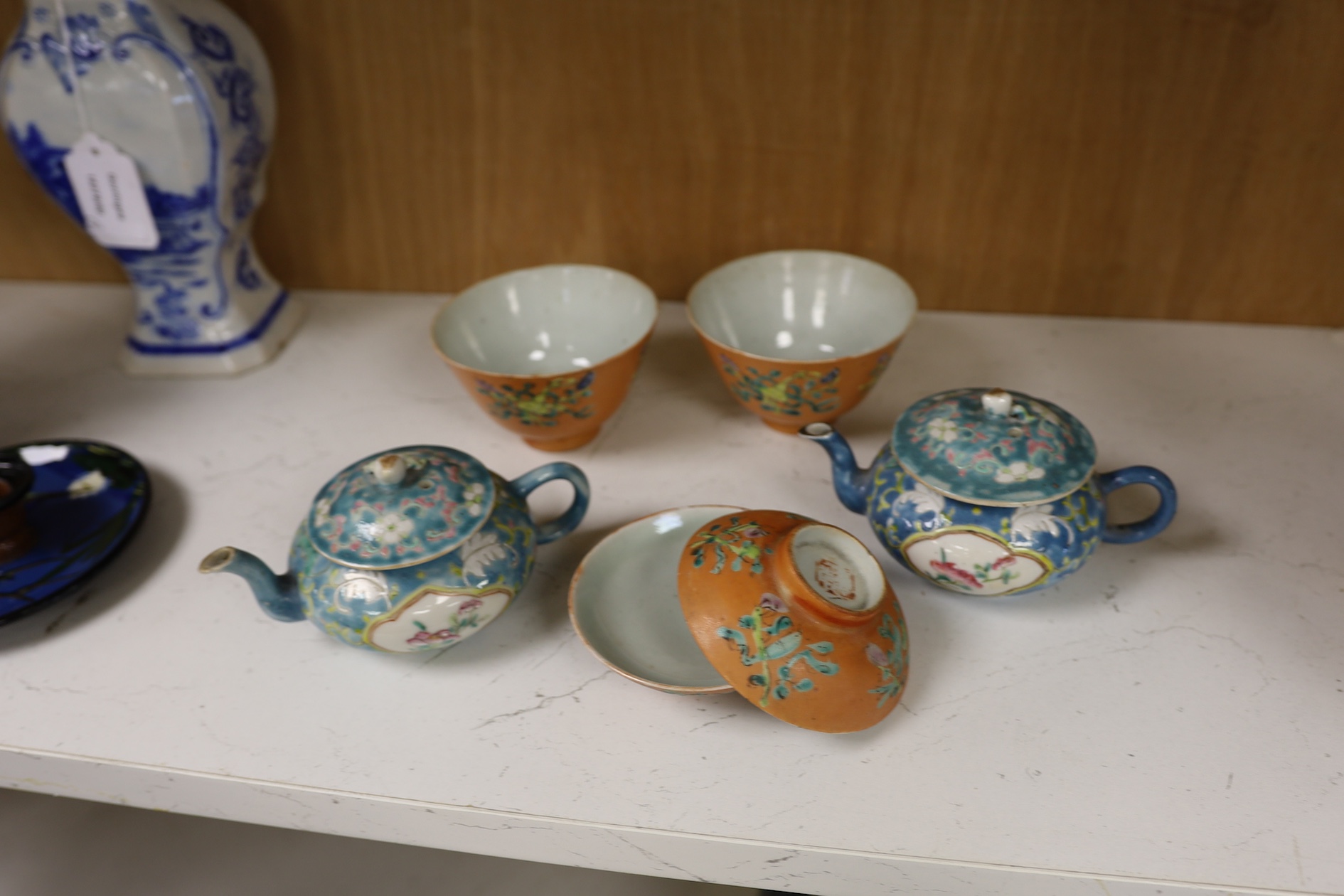 Two Chinese blue ground teapots, Tongzhi mark, and a pair of orange ground bowls and covers, teapots 15cm wide. Condition - fair